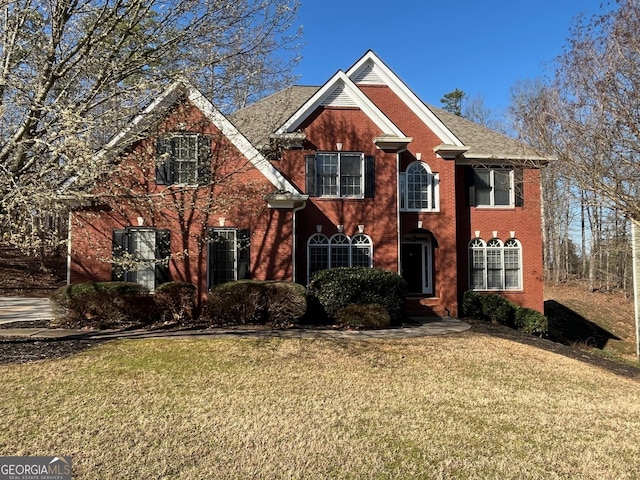 view of front of property with brick siding and a front yard