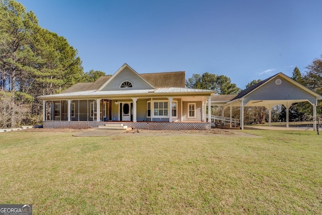 view of front of home featuring a porch, a sunroom, metal roof, and a front lawn