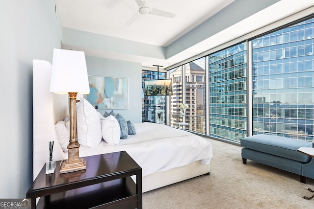 carpeted bedroom with floor to ceiling windows and a ceiling fan