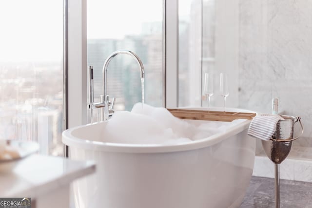 bathroom featuring tile walls and a sink