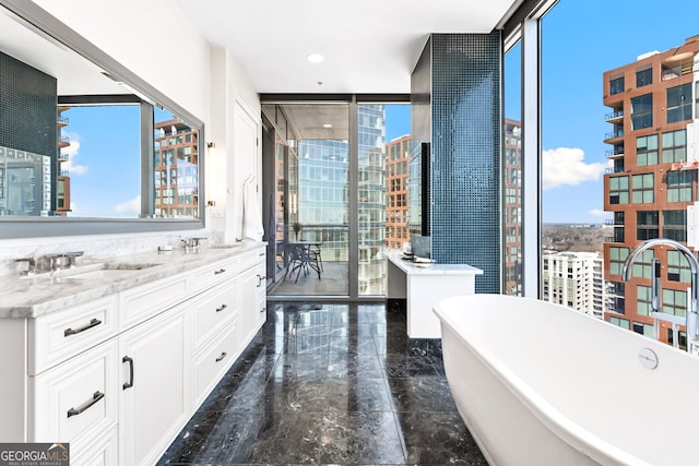 1065 Peachtree St NE Unit 3105, Atlanta, GA 30309 - full bath with floor to ceiling windows, healthy amount of natural light, marble tiled floors, a freestanding tub, and double vanity