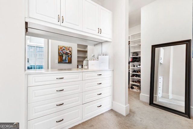 spacious closet featuring light carpet