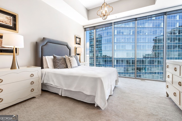 carpeted bedroom with a chandelier and expansive windows