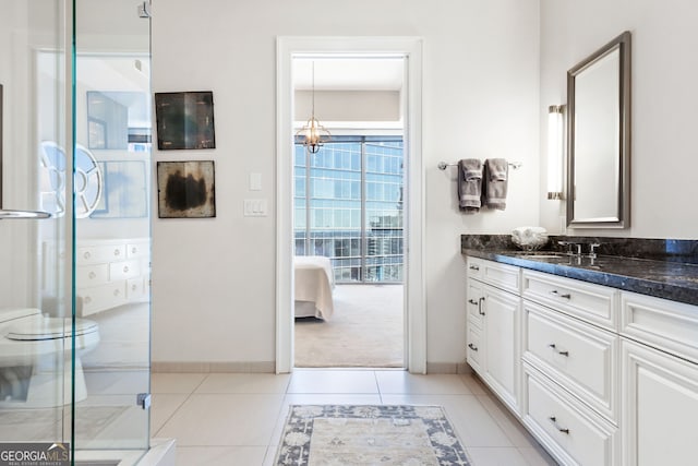 ensuite bathroom featuring ensuite bath, a shower stall, tile patterned flooring, a chandelier, and vanity