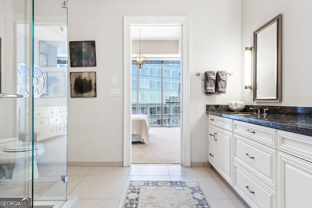1065 Peachtree St NE Unit 3105, Atlanta, GA 30309 - bathroom featuring a shower stall, vanity, a chandelier, baseboards, and ensuite bathroom