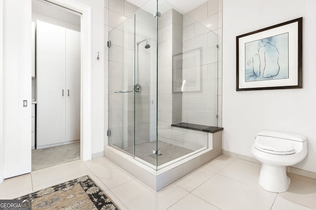 1065 Peachtree St NE Unit 3105, Atlanta, GA 30309 - bathroom with a shower stall, tile patterned floors, baseboards, and toilet