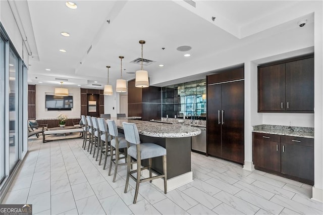 1065 Peachtree St NE Unit 3105, Atlanta, GA 30309 - kitchen with light marble finish floors, built in refrigerator, open floor plan, a breakfast bar area, and recessed lighting