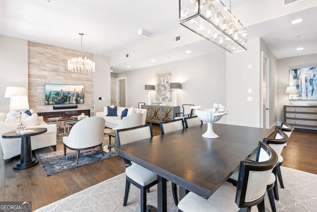 dining space featuring a notable chandelier, visible vents, recessed lighting, and hardwood / wood-style flooring