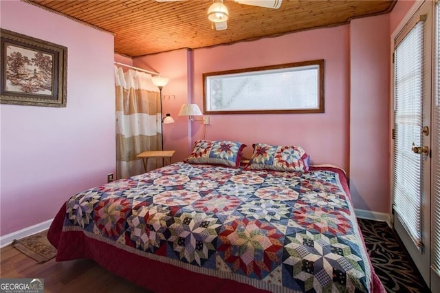 bedroom featuring wooden ceiling, baseboards, and wood finished floors