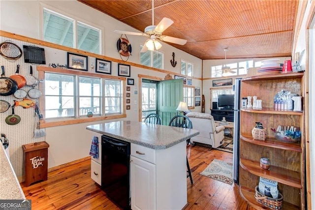 kitchen with wallpapered walls, wood ceiling, vaulted ceiling, and a wealth of natural light