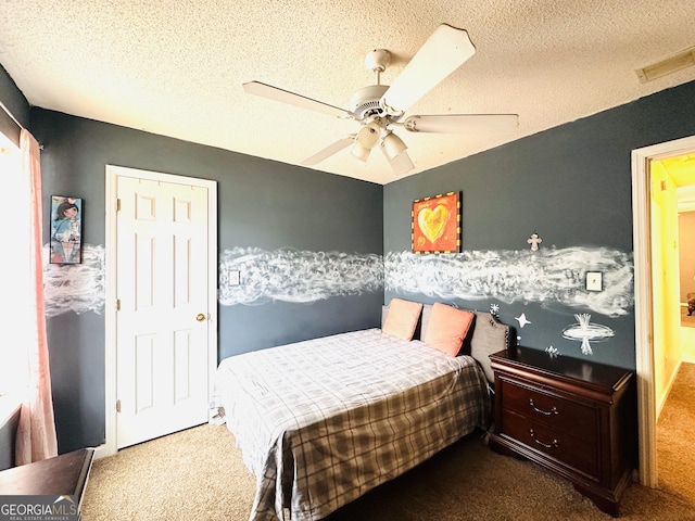 carpeted bedroom with visible vents, ceiling fan, and a textured ceiling