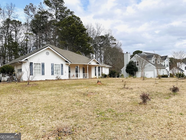 ranch-style home with covered porch and a front yard