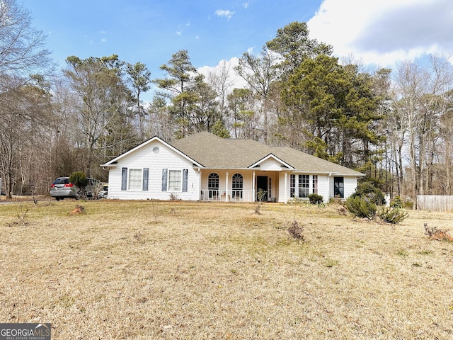 ranch-style house featuring a porch and a front lawn