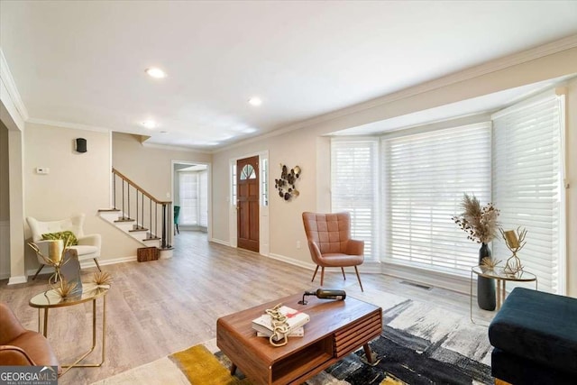 living area with light wood-style flooring, recessed lighting, baseboards, stairs, and ornamental molding