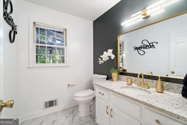 half bathroom featuring toilet, vanity, visible vents, baseboards, and marble finish floor