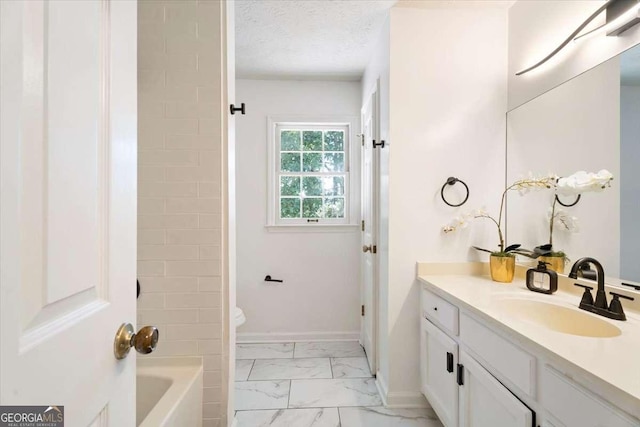 bathroom featuring baseboards, toilet, marble finish floor, a textured ceiling, and vanity