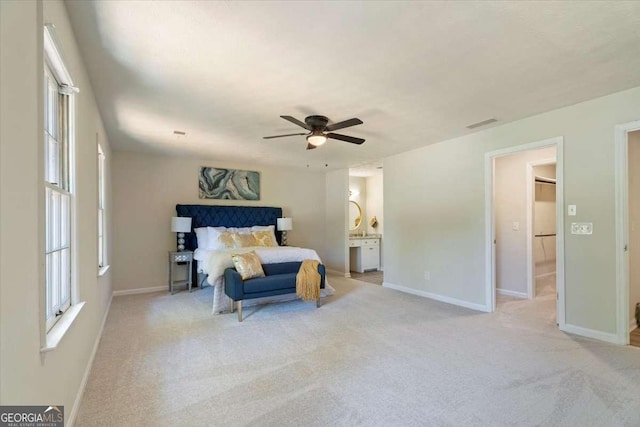 bedroom with baseboards, multiple windows, and light colored carpet