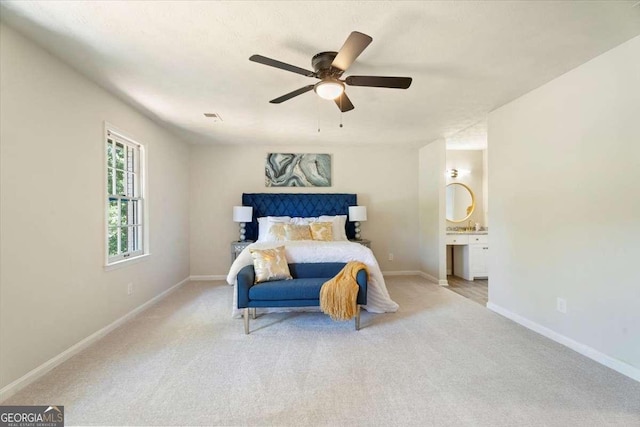 bedroom featuring carpet, visible vents, baseboards, and ensuite bathroom