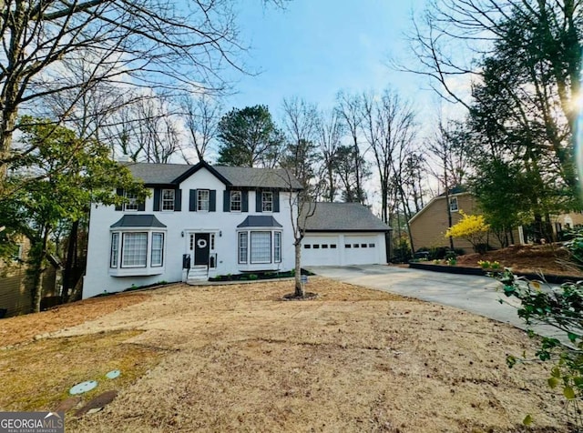 colonial home with a garage and concrete driveway