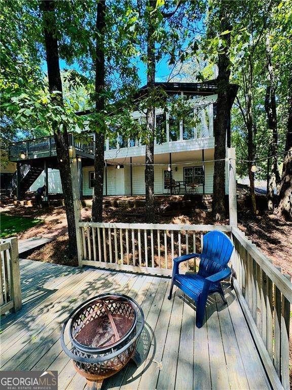 wooden deck featuring an outdoor fire pit