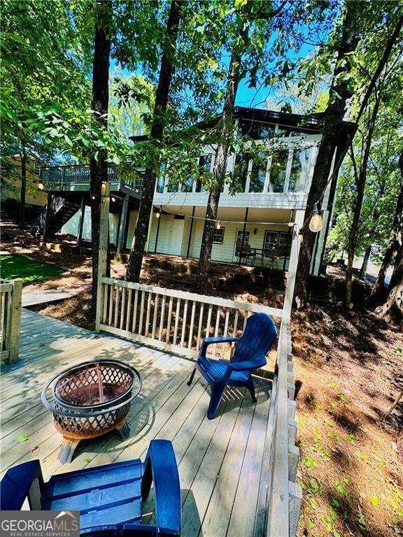 wooden deck with an outdoor fire pit