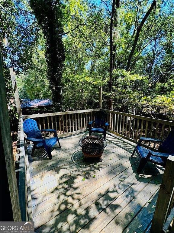 wooden deck featuring a fire pit