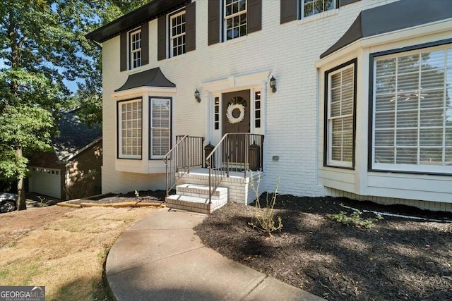 property entrance featuring brick siding