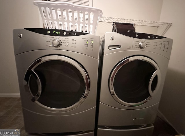 washroom with tile patterned flooring, baseboards, and washing machine and clothes dryer