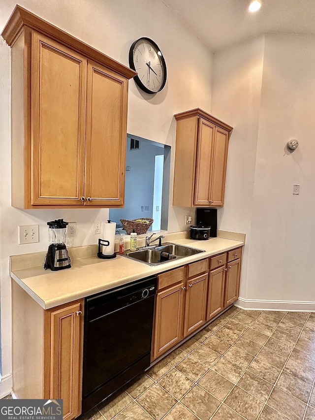 kitchen with a sink, brown cabinets, light countertops, and dishwasher