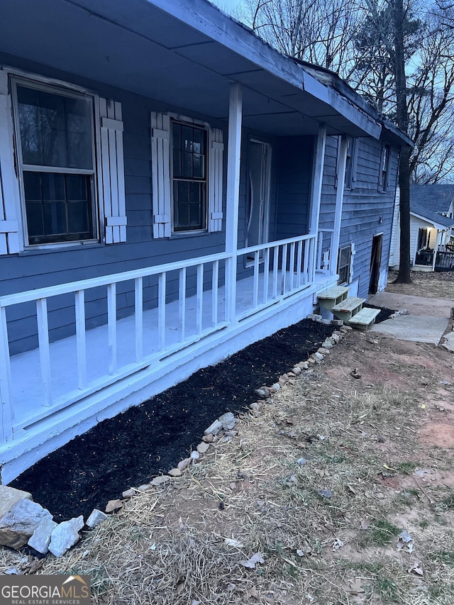 view of side of home featuring a porch