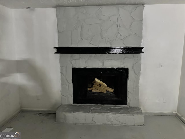 interior details with a fireplace with raised hearth and baseboards