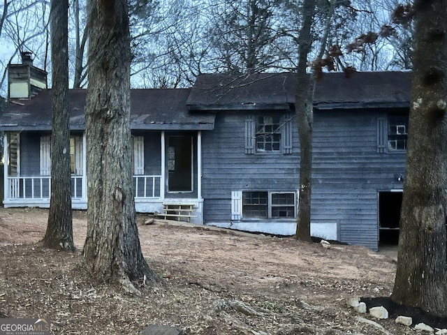 rear view of property with a sunroom