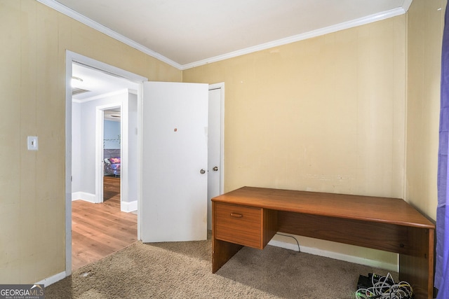 office area with light carpet, baseboards, and crown molding