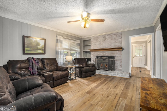 living area featuring a textured ceiling, plenty of natural light, crown molding, and hardwood / wood-style floors