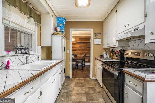 kitchen featuring tile countertops, white cabinetry, stainless steel range with electric stovetop, and under cabinet range hood