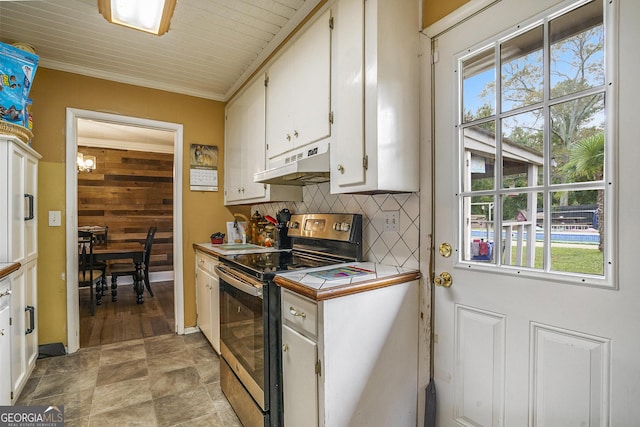 kitchen featuring under cabinet range hood, white cabinets, stainless steel electric range, tile counters, and tasteful backsplash