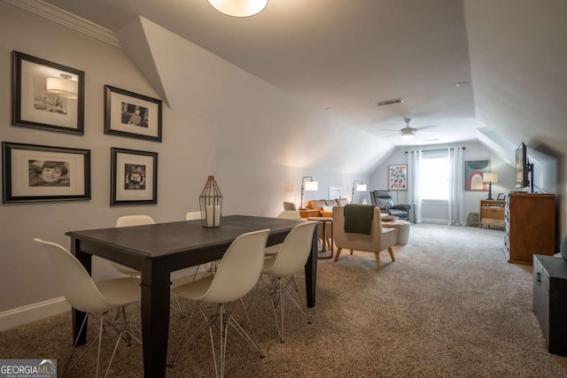 carpeted dining area with vaulted ceiling, visible vents, and baseboards