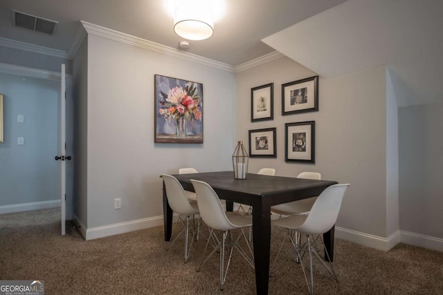 dining space featuring baseboards, carpet, visible vents, and crown molding