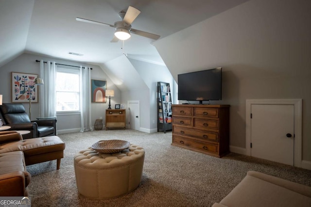 interior space with carpet floors, visible vents, a ceiling fan, vaulted ceiling, and baseboards