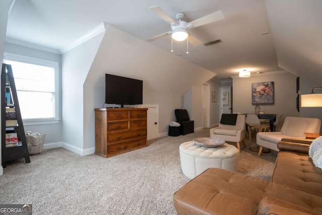 carpeted living area featuring baseboards, visible vents, a ceiling fan, lofted ceiling, and crown molding