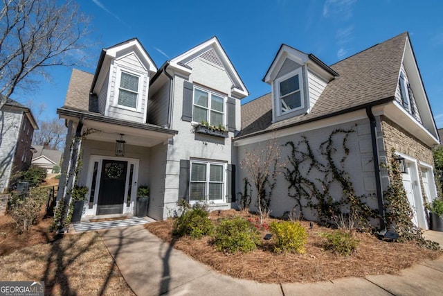 traditional-style home featuring a shingled roof