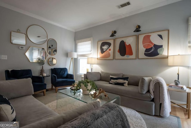 living room with baseboards, crown molding, visible vents, and wood finished floors