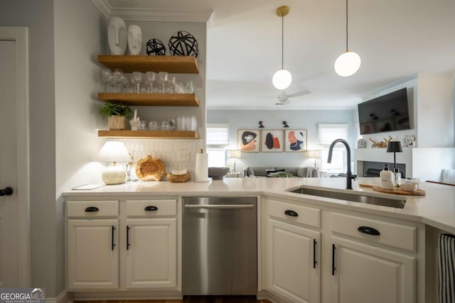 kitchen featuring light countertops, a sink, stainless steel dishwasher, and white cabinetry