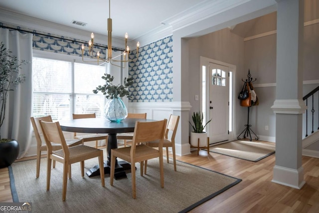 dining room with a notable chandelier, visible vents, ornamental molding, wood finished floors, and baseboards