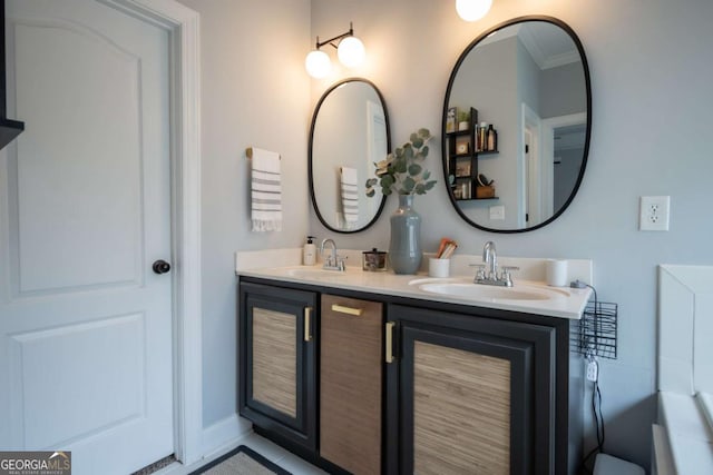 bathroom featuring double vanity, ornamental molding, a sink, and baseboards