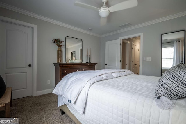 carpeted bedroom with baseboards, visible vents, a ceiling fan, and ornamental molding