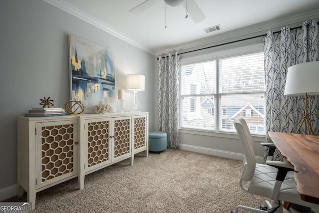 carpeted office space featuring visible vents, crown molding, baseboards, and ceiling fan