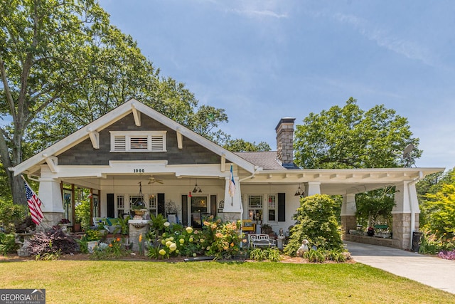 1000 NW Main St, Conyers, GA 30012 - craftsman inspired home with driveway, ceiling fan, a chimney, covered porch, and a front yard