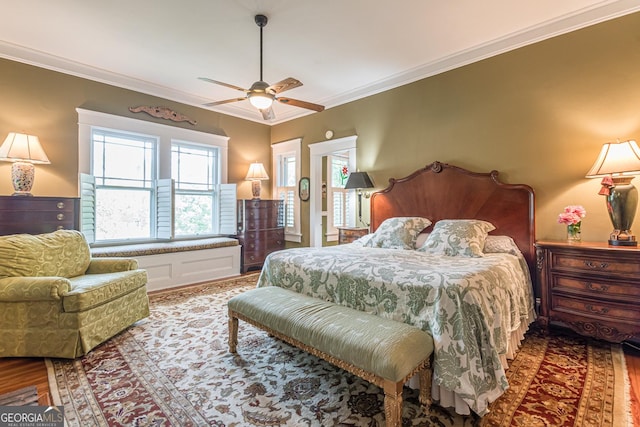 bedroom with ceiling fan, crown molding, and wood finished floors