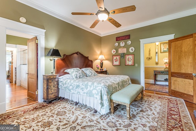 bedroom featuring baseboards, wood finished floors, a ceiling fan, and crown molding